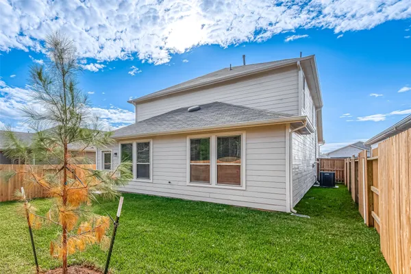 a view of a house with a backyard