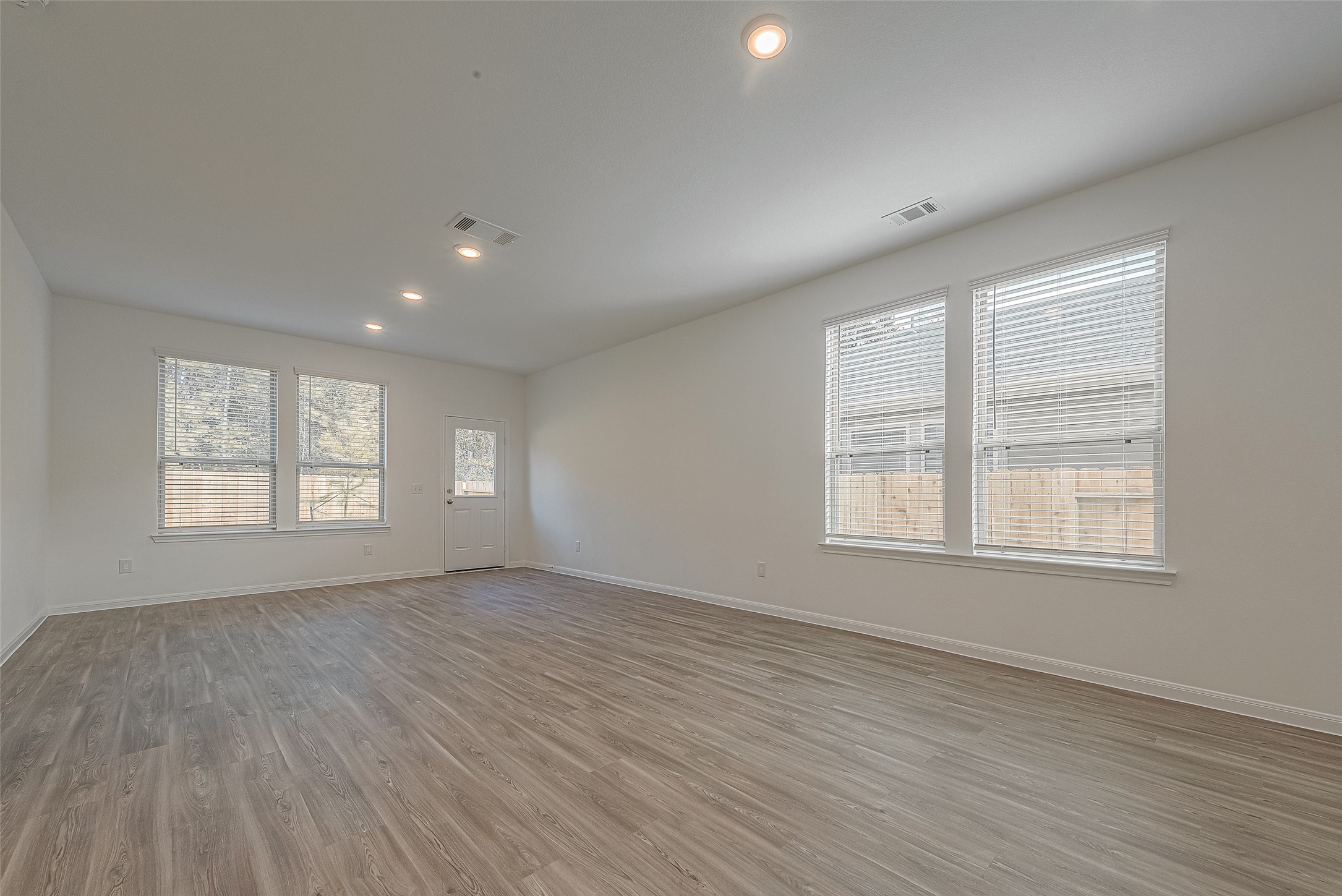 325 Maple Bark Trail Willis, TX 77378 - Photo 7 of 22 an empty room with wooden floor and windows