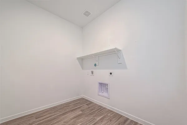 a view of room with wooden floor