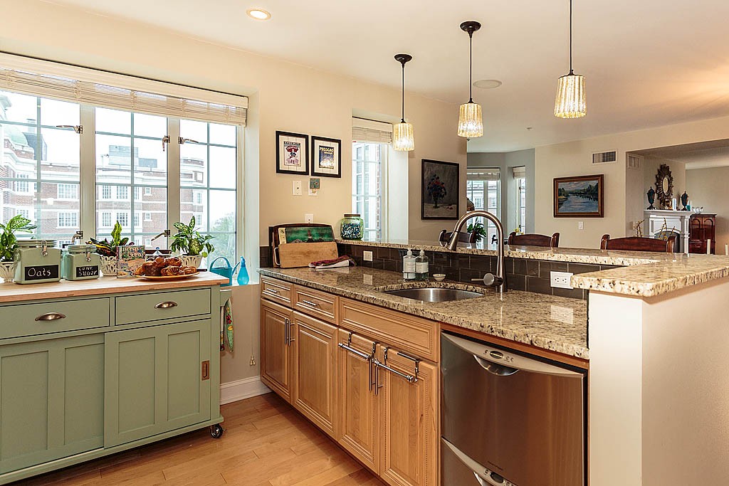 20 Chapel Street, Unit C1001 Brookline, MA 02446 - Photo 13 of 28 a kitchen with lots of counter space and a wooden floor