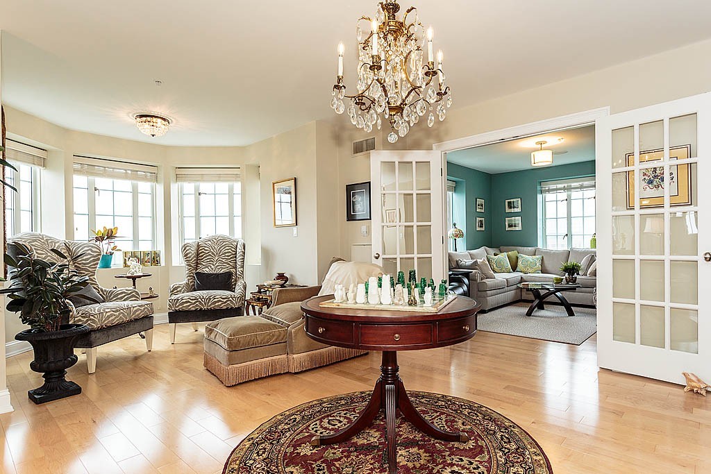 20 Chapel Street, Unit C1001 Brookline, MA 02446 - Photo 4 of 28 a living room with fireplace furniture and a chandelier