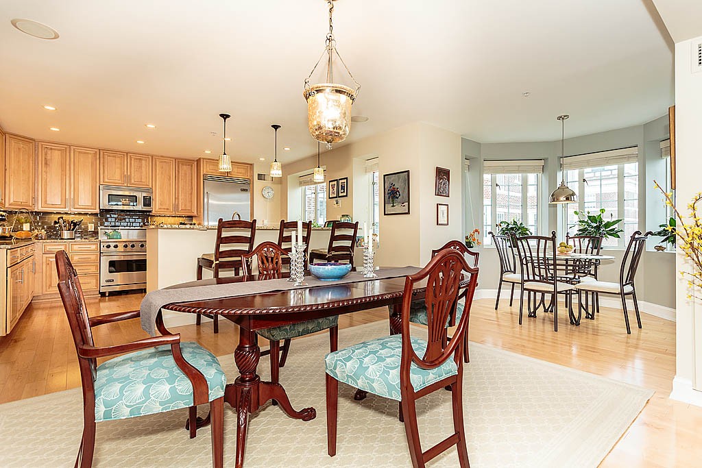 20 Chapel Street, Unit C1001 Brookline, MA 02446 - Photo 9 of 28 a dining room with stainless steel appliances kitchen island granite countertop a table and chairs