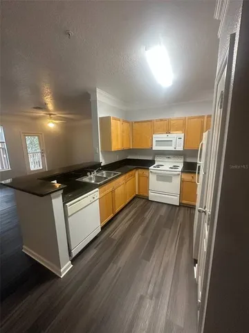 a kitchen with stainless steel appliances a refrigerator and a stove top oven