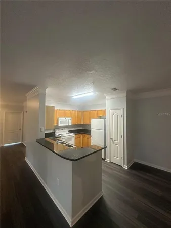 a kitchen with stainless steel appliances granite countertop a sink and a stove