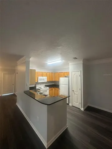 a kitchen with stainless steel appliances granite countertop a sink and a stove