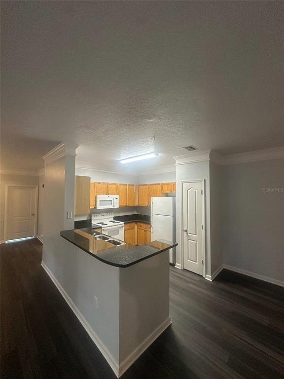 19935 Villa Isle Drive Orlando, FL 32821 - Photo 5 of 17 a kitchen with stainless steel appliances granite countertop a sink and a stove