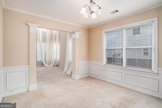 an empty room with a fireplace and windows