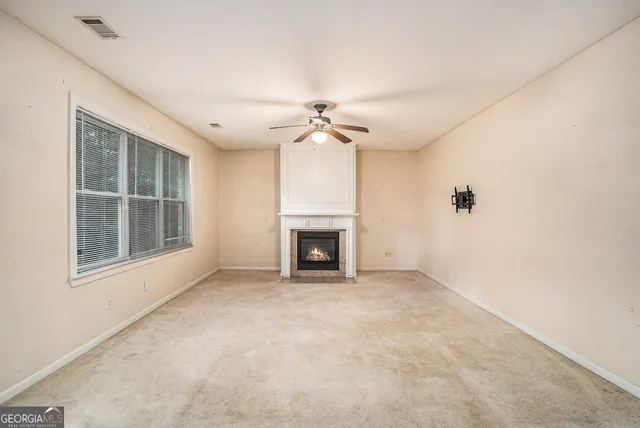 a kitchen with stainless steel appliances granite countertop a refrigerator a stove top oven a sink dishwasher and wooden cabinets with wooden floor