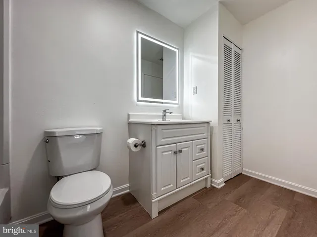 a bathroom with a toilet sink and mirror