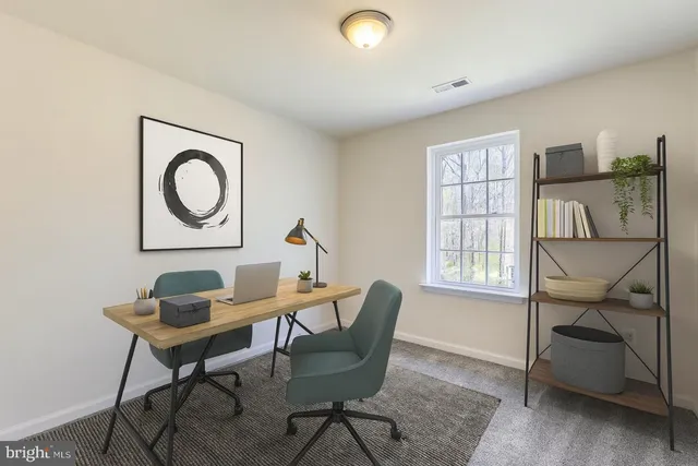 a view of a livingroom with furniture and a window