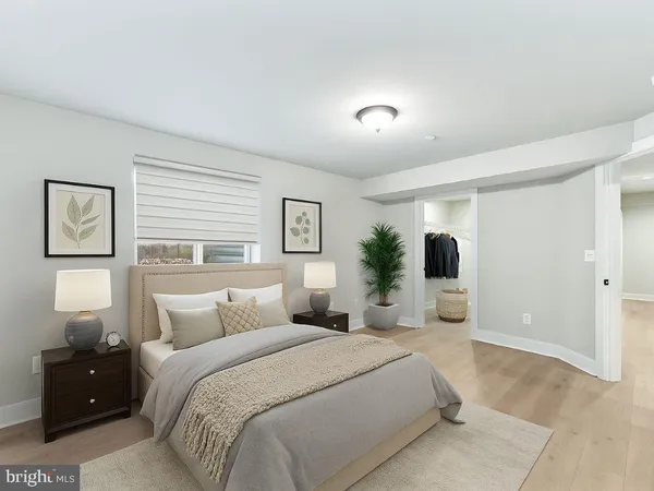 a bedroom with a large bed and a window