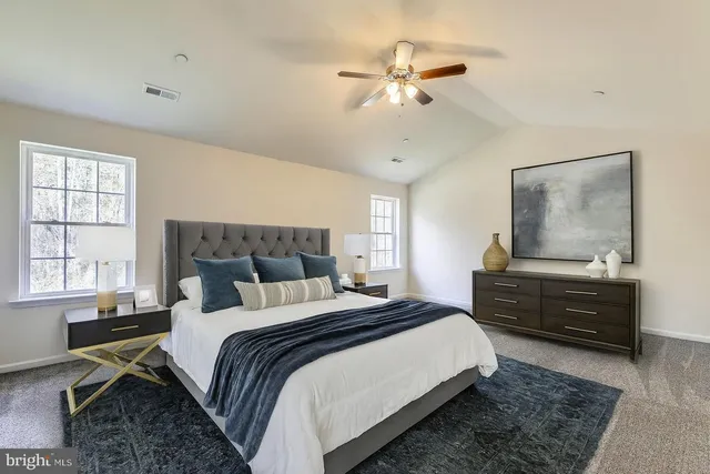 a bedroom with double bed windows and a chandelier