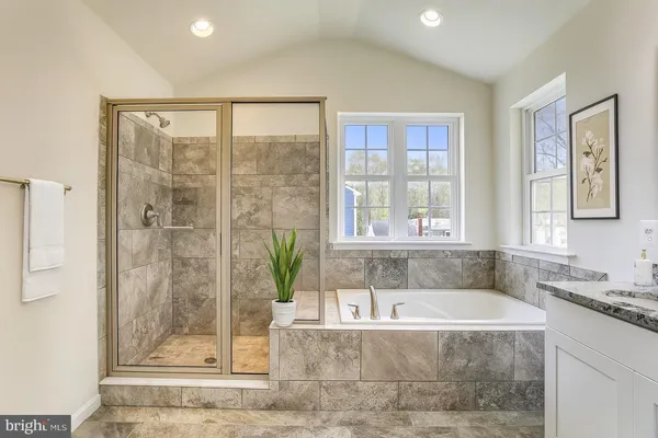 a bath tub sitting next to a window