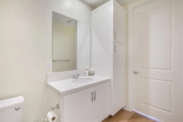 a bedroom with a large bed and wooden floor