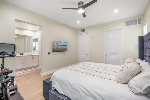 a bedroom with a large bed and a chandelier