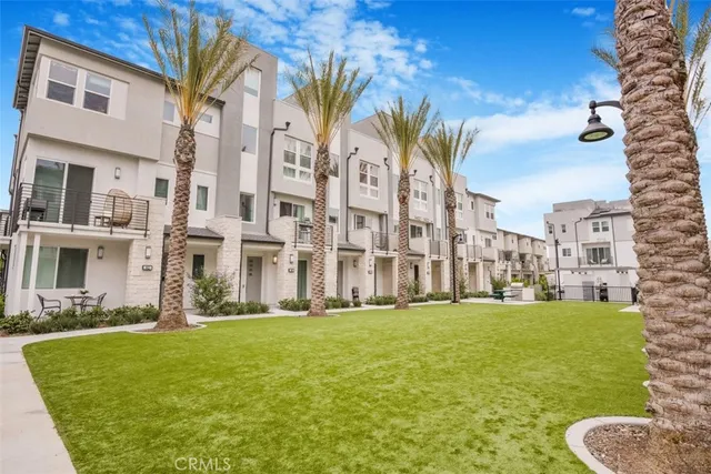 a view of a street with tall buildings