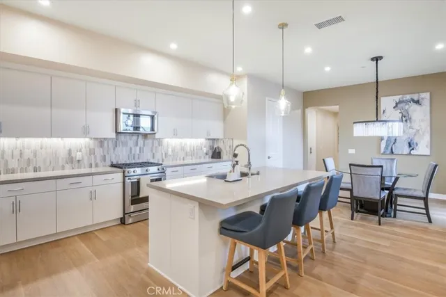 a kitchen with refrigerator and cabinets