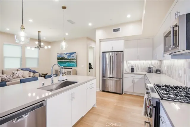 a living room with furniture a chandelier and a chandelier
