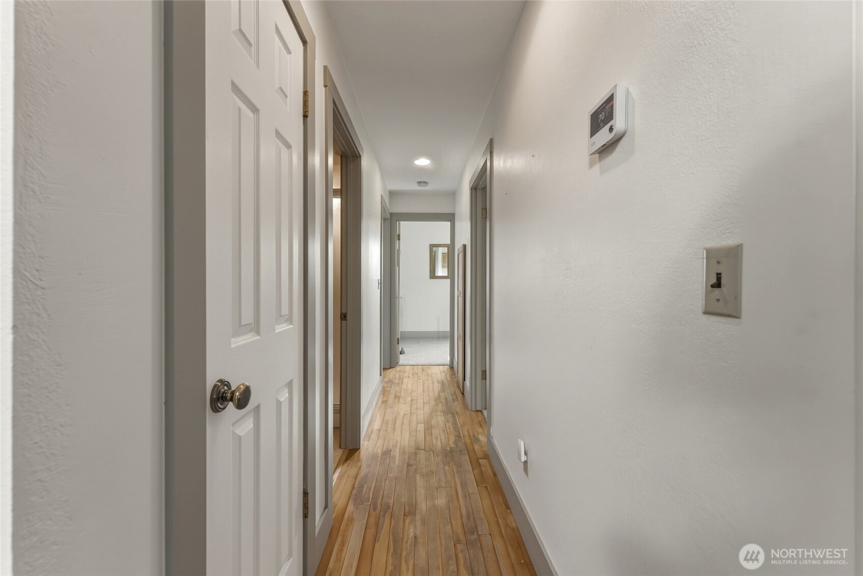 5834 Russell Creek Road Walla Walla, WA 99362 - Photo 17 of 38 a view of a hallway with wooden floor and a bathroom