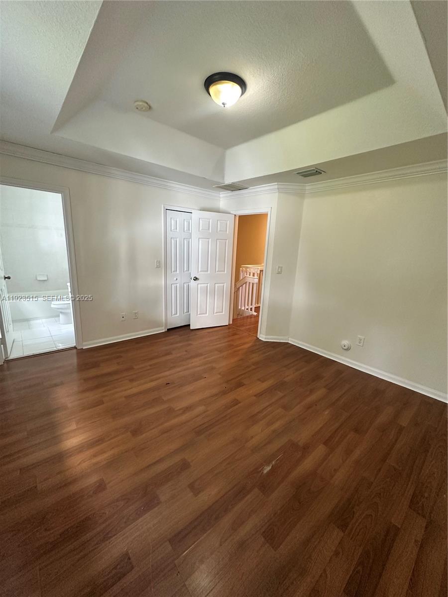 2704 Southeast 15th Place, Unit 152 Homestead, FL 33035 - Photo 15 of 35 an empty room with wooden floor and windows