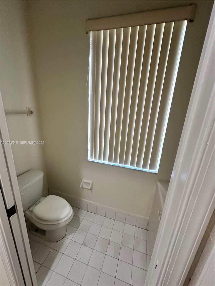 2704 Southeast 15th Place, Unit 152 Homestead, FL 33035 - Photo 27 of 35 a white toilet sitting next to a window