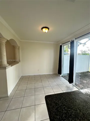 a view of a room with a sink and cabinets