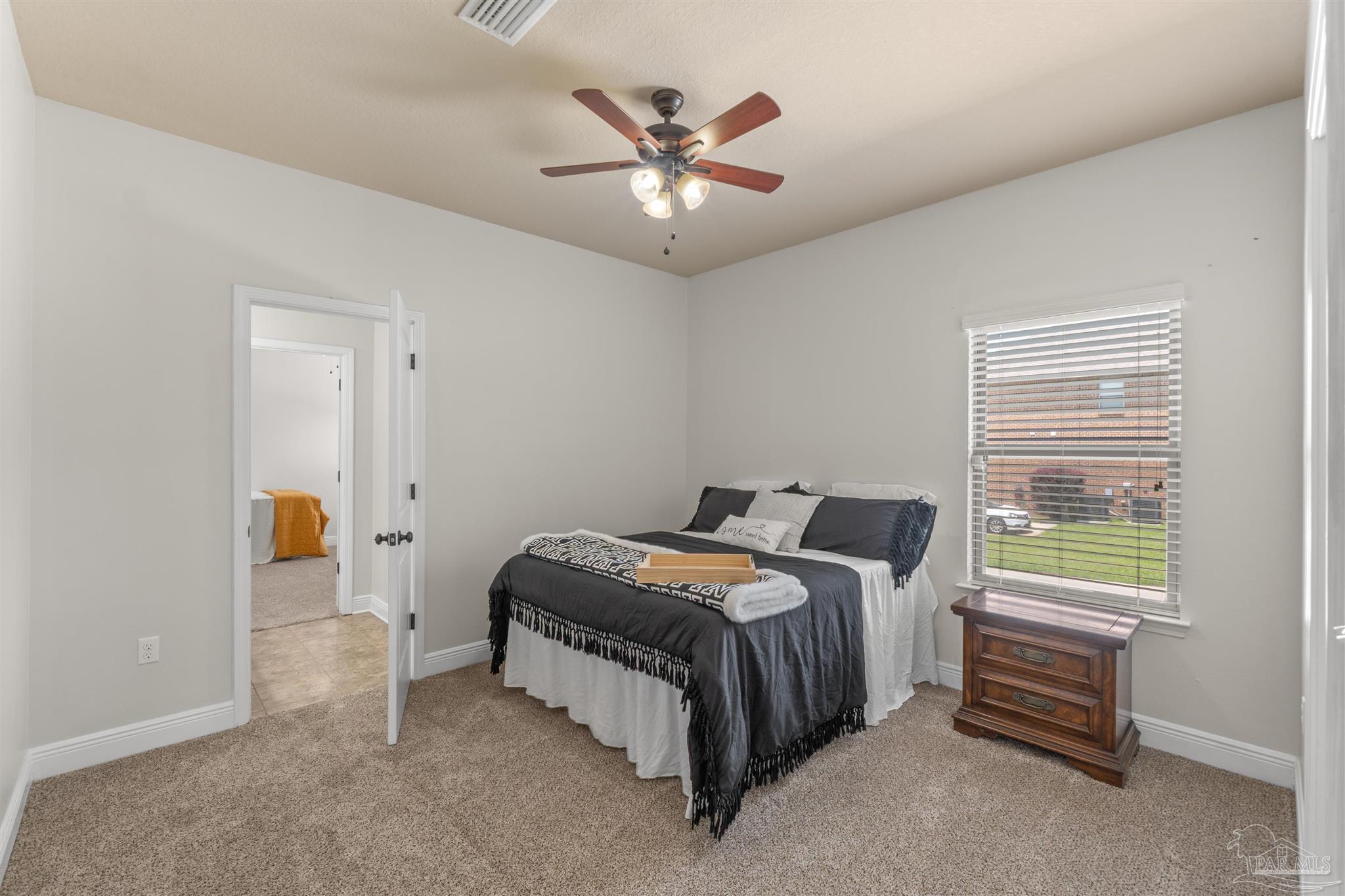 2698 Tulip Hill Road Pace, FL 32571 - Photo 31 of 65 a bedroom with a bed and a ceiling fan