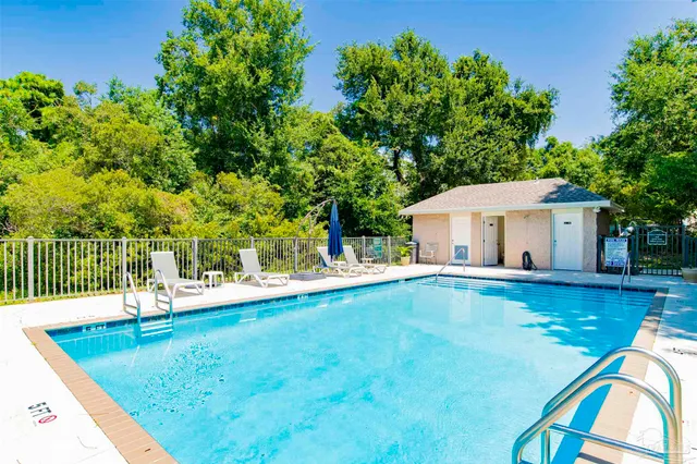 a view of a house with pool and a yard
