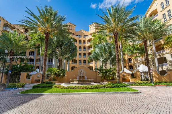 a front view of a building with a garden