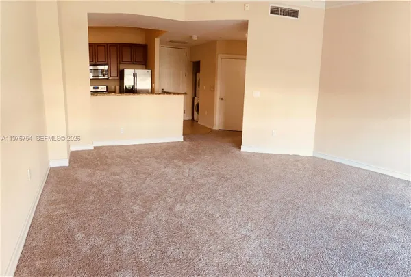 a view of kitchen and kitchen with stainless steel appliances