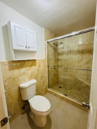 a bathroom with a toilet and a shower