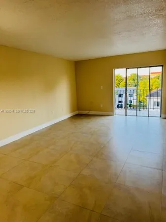 a view of an empty room with a floor to ceiling window