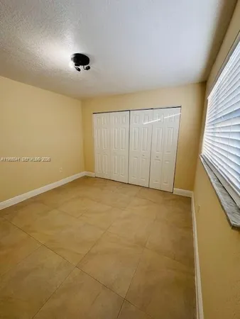 an empty room with a empty space and windows