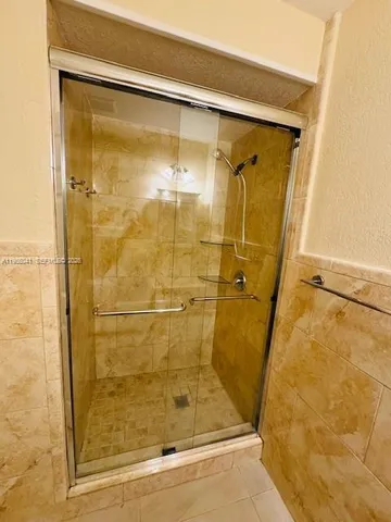 a bathroom with a glass shower door