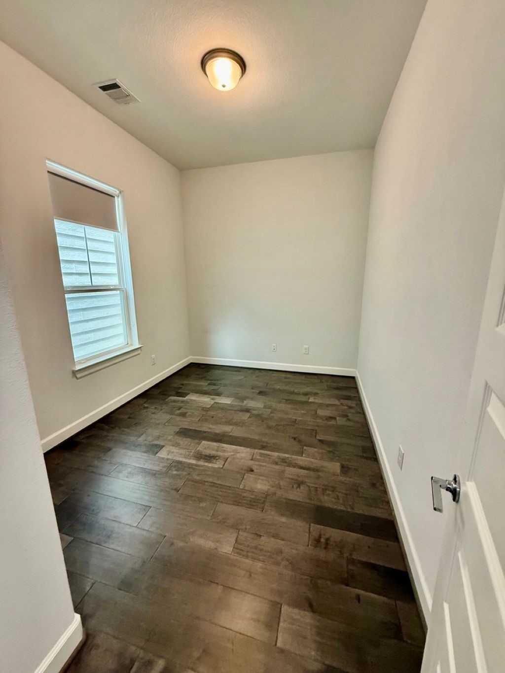 307 Parker Street Houston, TX 77007 - Photo 11 of 25 an empty room with wooden floor and windows