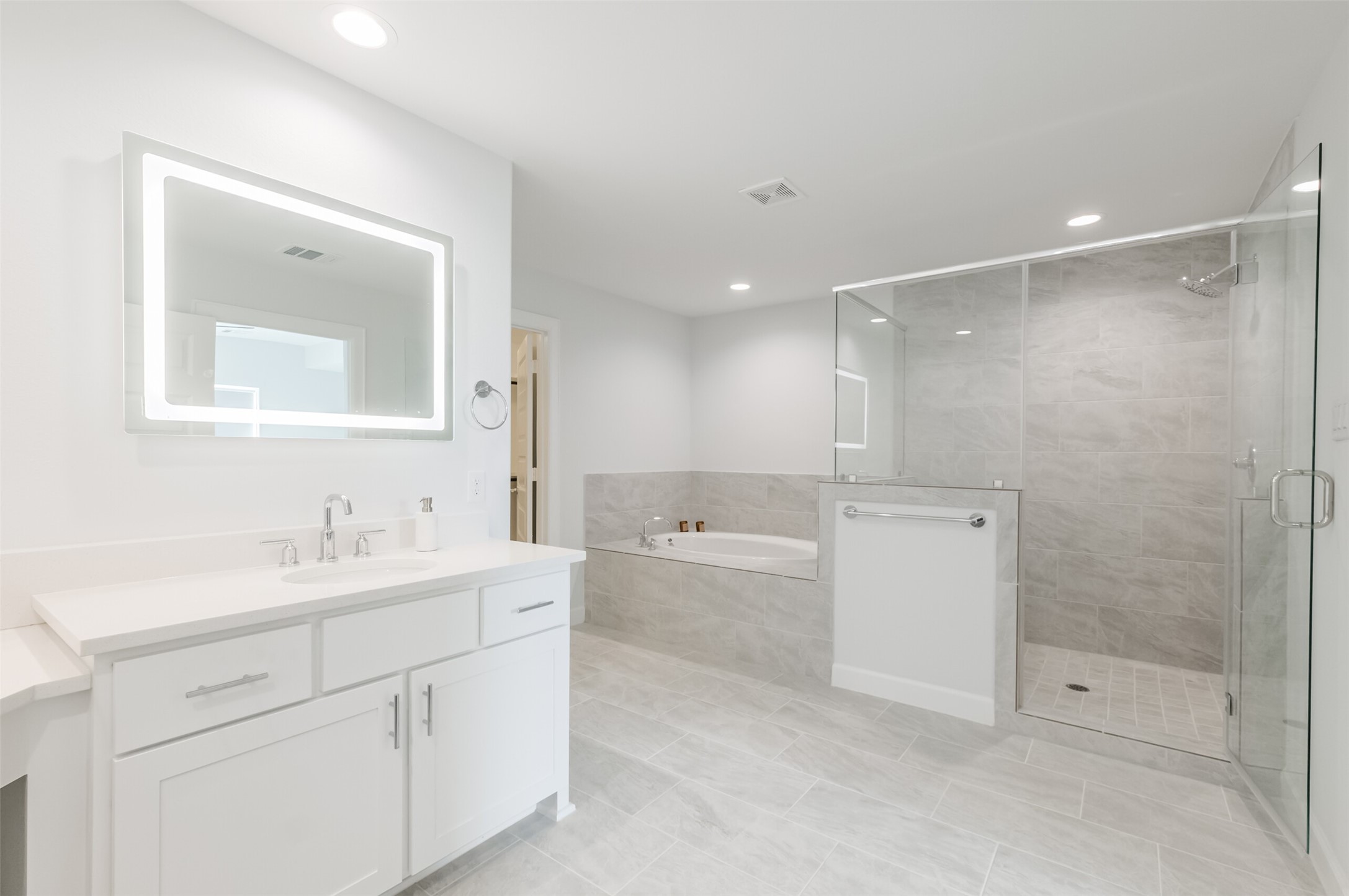 307 Parker Street Houston, TX 77007 - Photo 14 of 25 a bathroom with a bathtub shower sink vanity and mirror