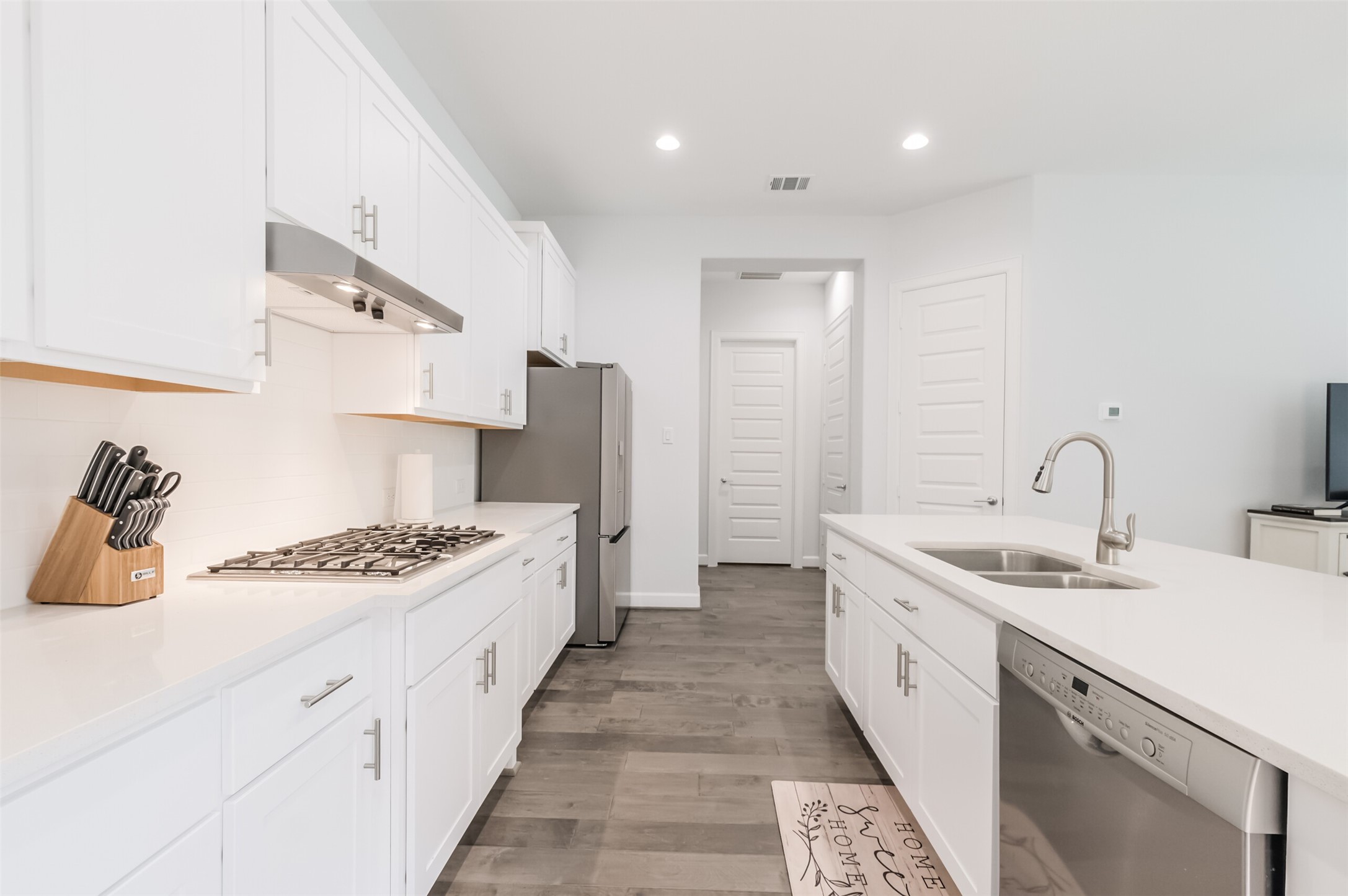 307 Parker Street Houston, TX 77007 - Photo 6 of 25 a kitchen with stainless steel appliances a sink dishwasher stove refrigerator and cabinets with wooden floor
