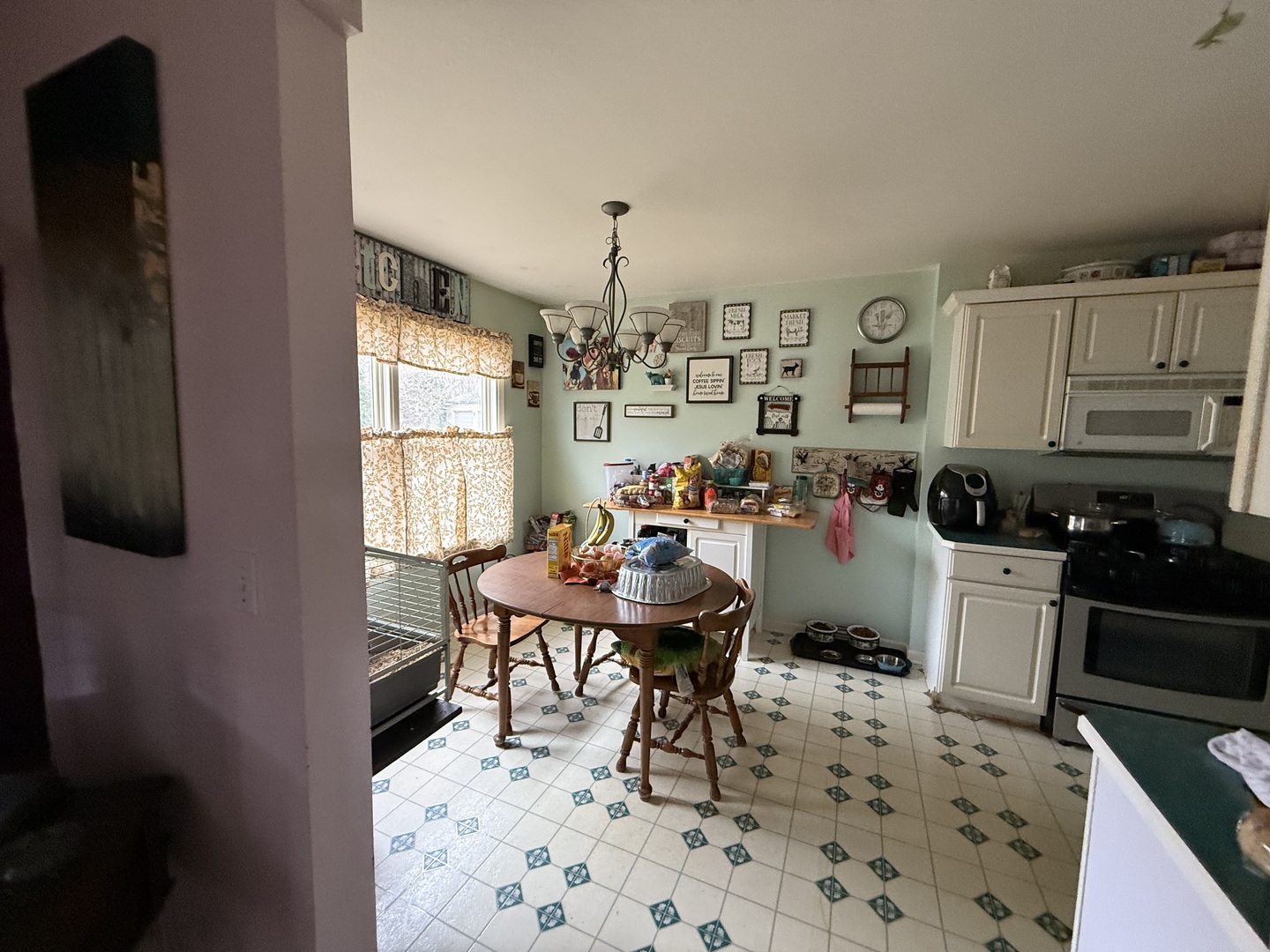 Undisclosed Address Itasca, IL 60143 - Photo 6 of 16 a kitchen with a dining table chairs and a refrigerator
