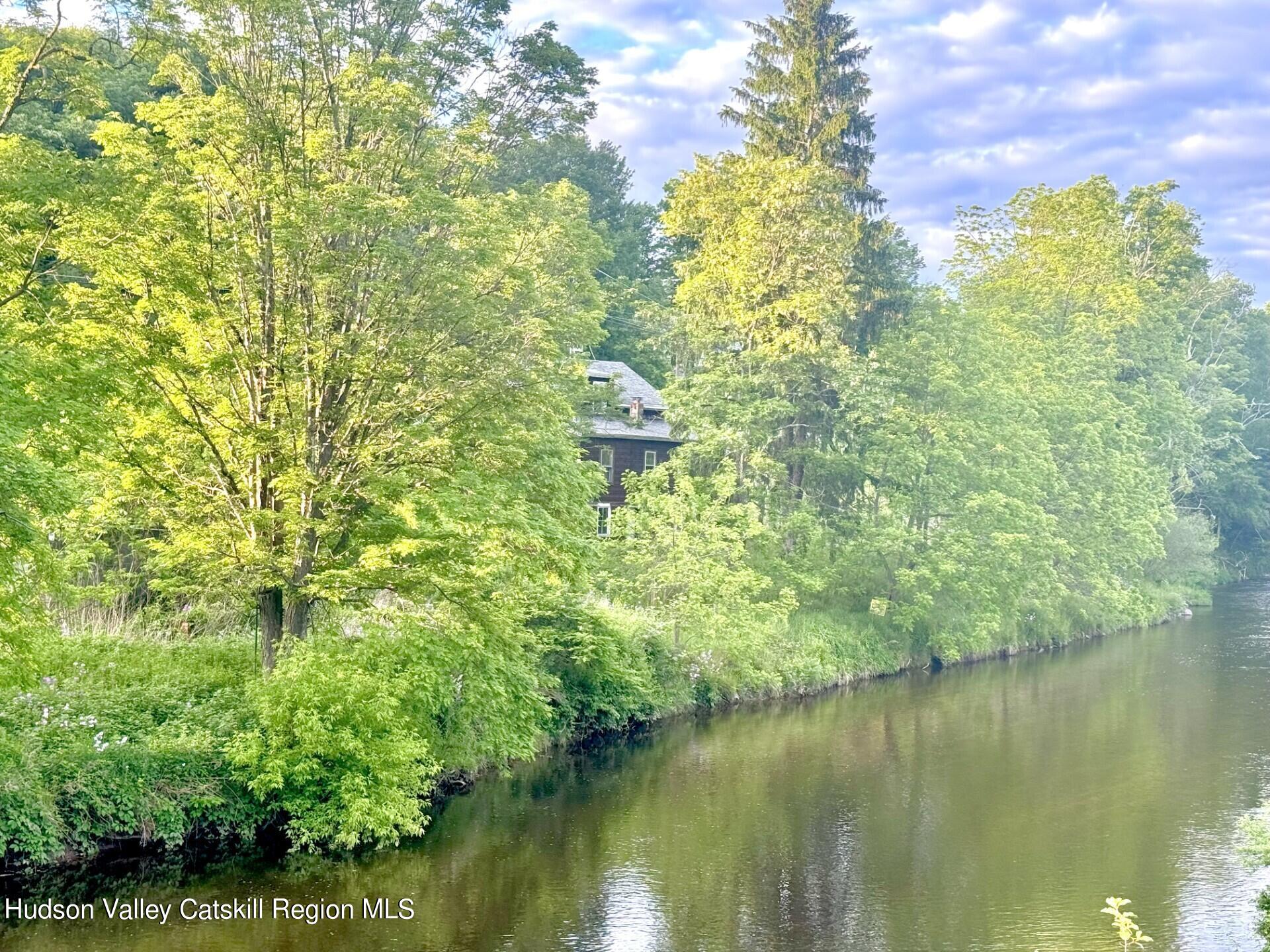 7 Old Rte 52, Unit 13 OLD ROUTE 52 Jeffersonville, NY 12748 - Photo 3 of 26 a backyard of a house with lots of green space and lake view