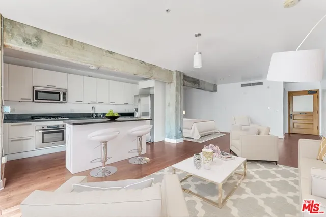 a kitchen with white cabinets and appliances