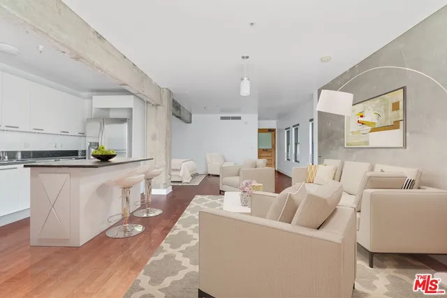 a living room with furniture a rug and white walls