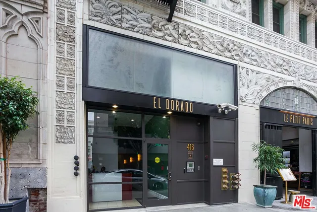 a front view of a building with potted plants