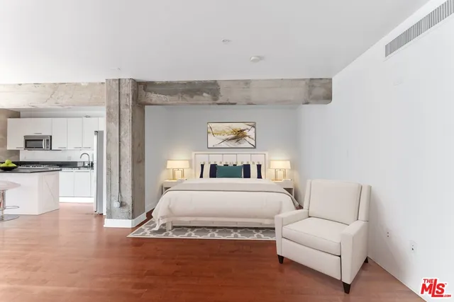 a spacious bedroom with a bed and a couch