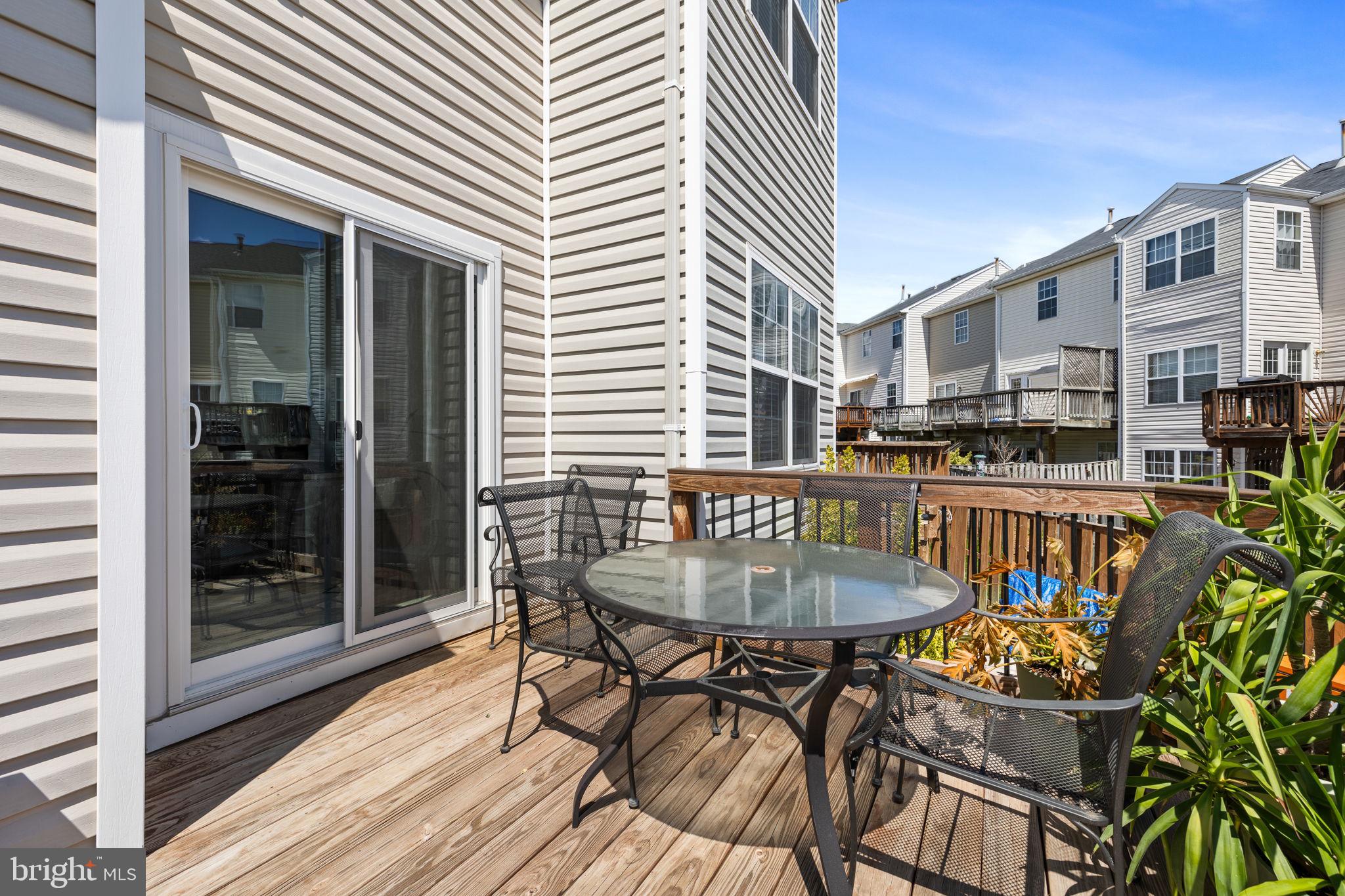 8777 Dunstable Loop Bristow, VA 20136 - Photo 21 of 25 a patio with table and chairs and potted plants