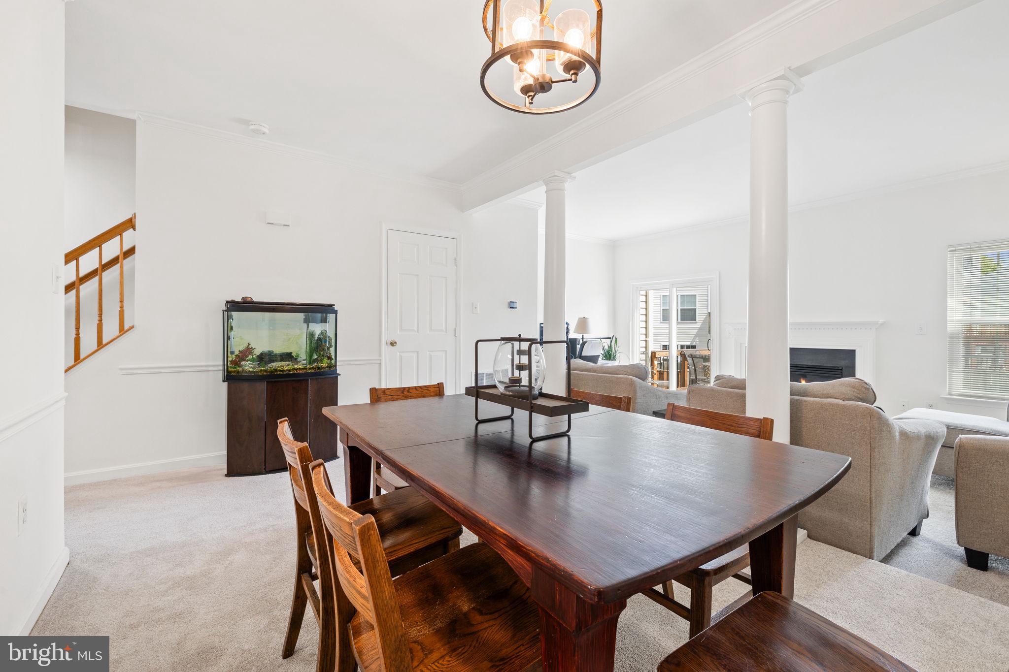 8777 Dunstable Loop Bristow, VA 20136 - Photo 7 of 25 a view of a dining room with furniture and wooden floor