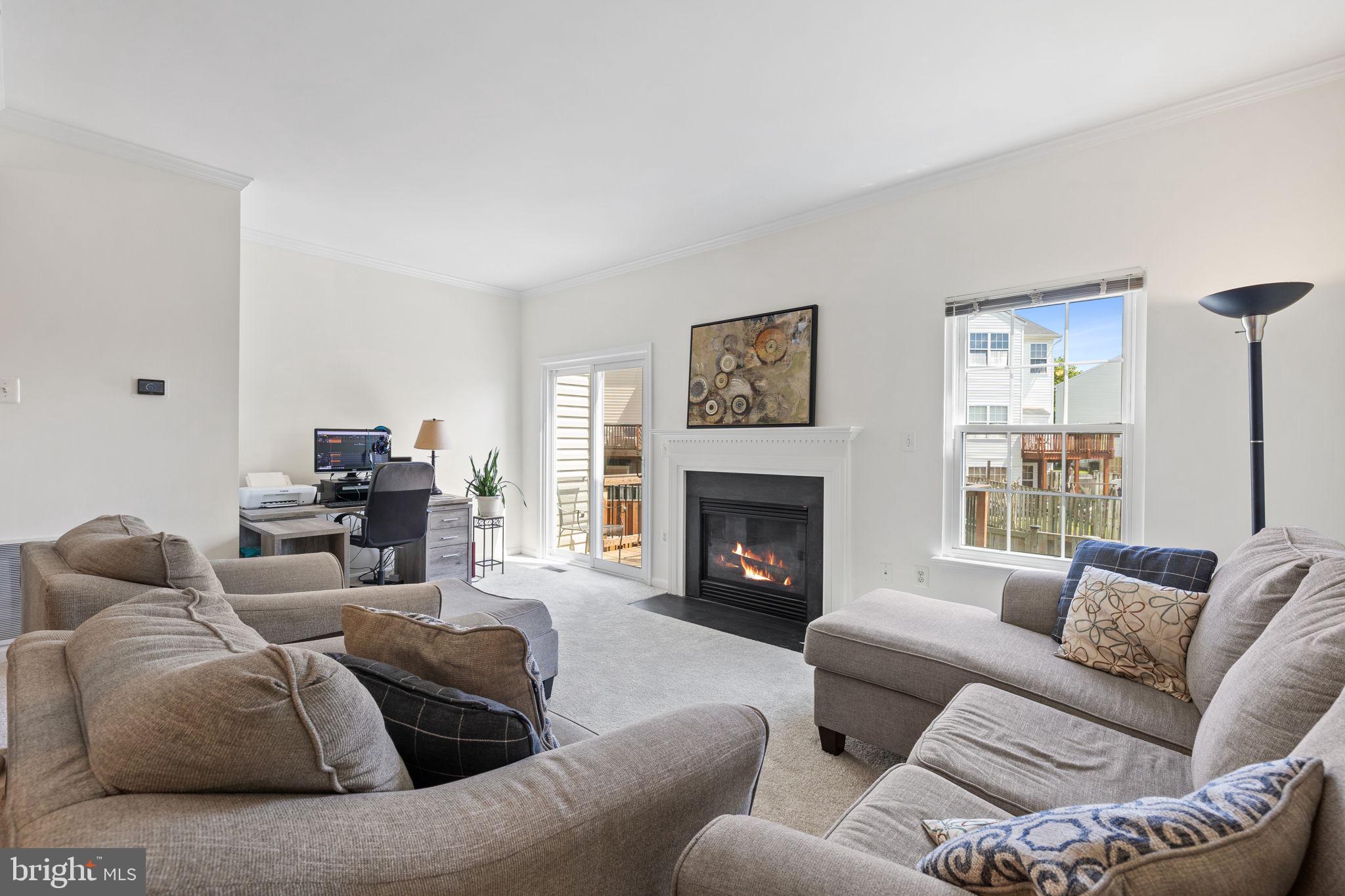 8777 Dunstable Loop Bristow, VA 20136 - Photo 9 of 25 a living room with furniture and a fireplace