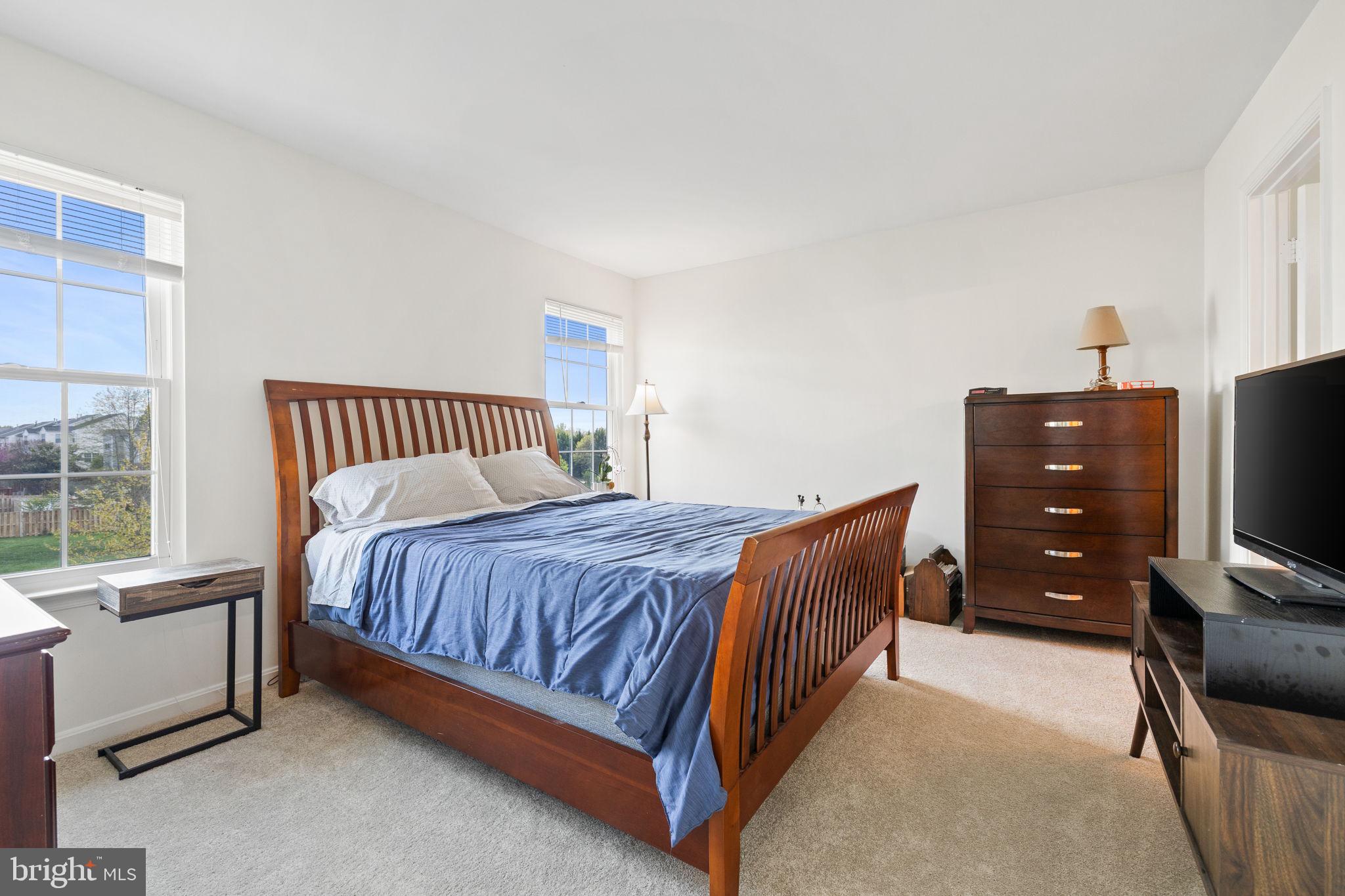8777 Dunstable Loop Bristow, VA 20136 - Photo 10 of 25 a bedroom with a bed and a tv