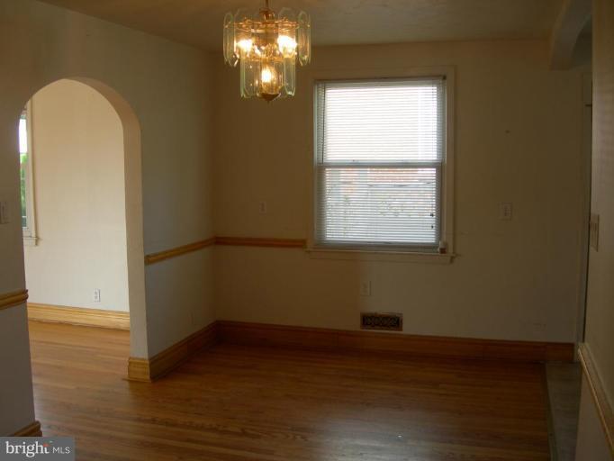 1815 Hanford Road Rosedale, MD 21237 - Photo 3 of 12 a view of empty room with wooden floor and fan