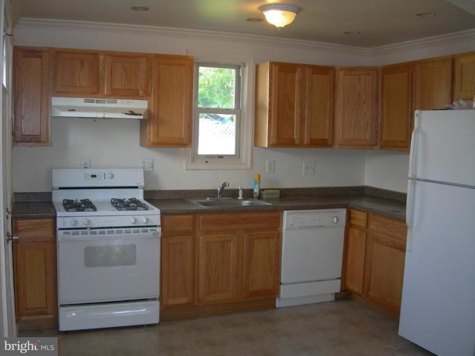 1815 Hanford Road Rosedale, MD 21237 - Photo 4 of 12 a kitchen with a stove sink and cabinets