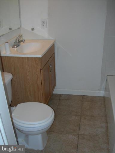 1815 Hanford Road Rosedale, MD 21237 - Photo 10 of 12 a bathroom with a sink a toilet and a mirror